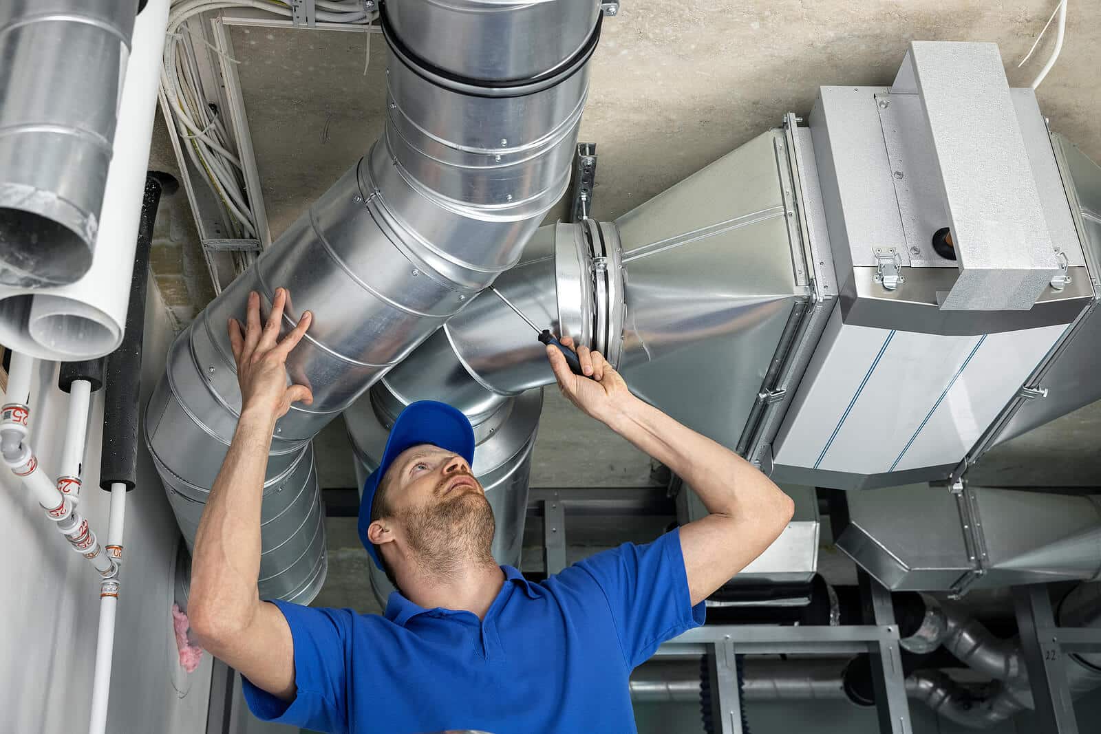 HVAC technician inspecting and repairing air ducts in Compton